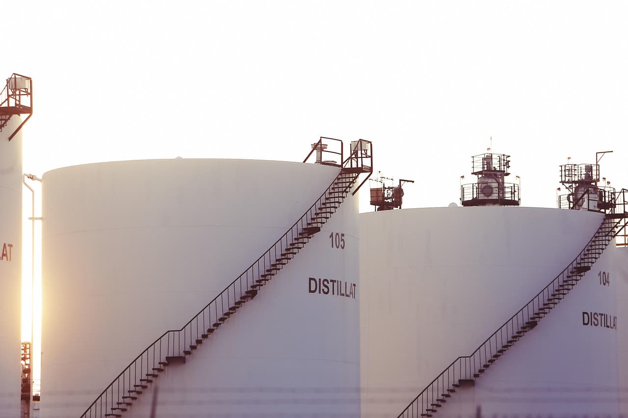 Large petrochemical distillation tanks and processing infrastructure at an industrial chemical facility
