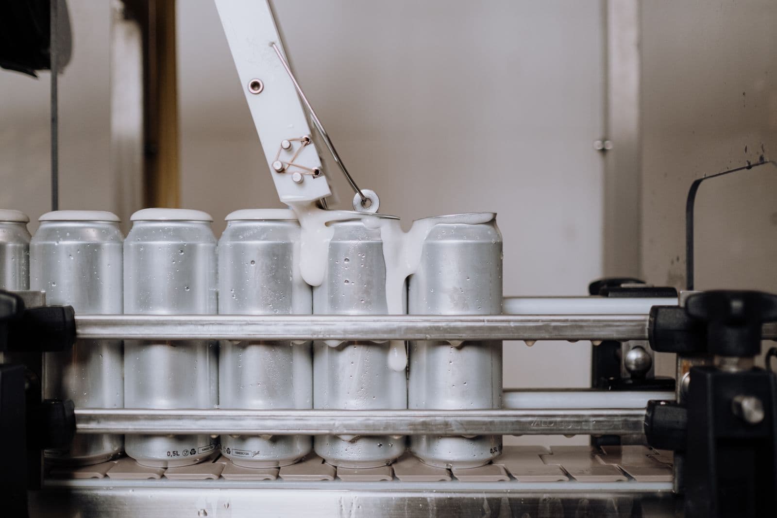 Aluminum cans on a modern beverage production line in a food manufacturing facility