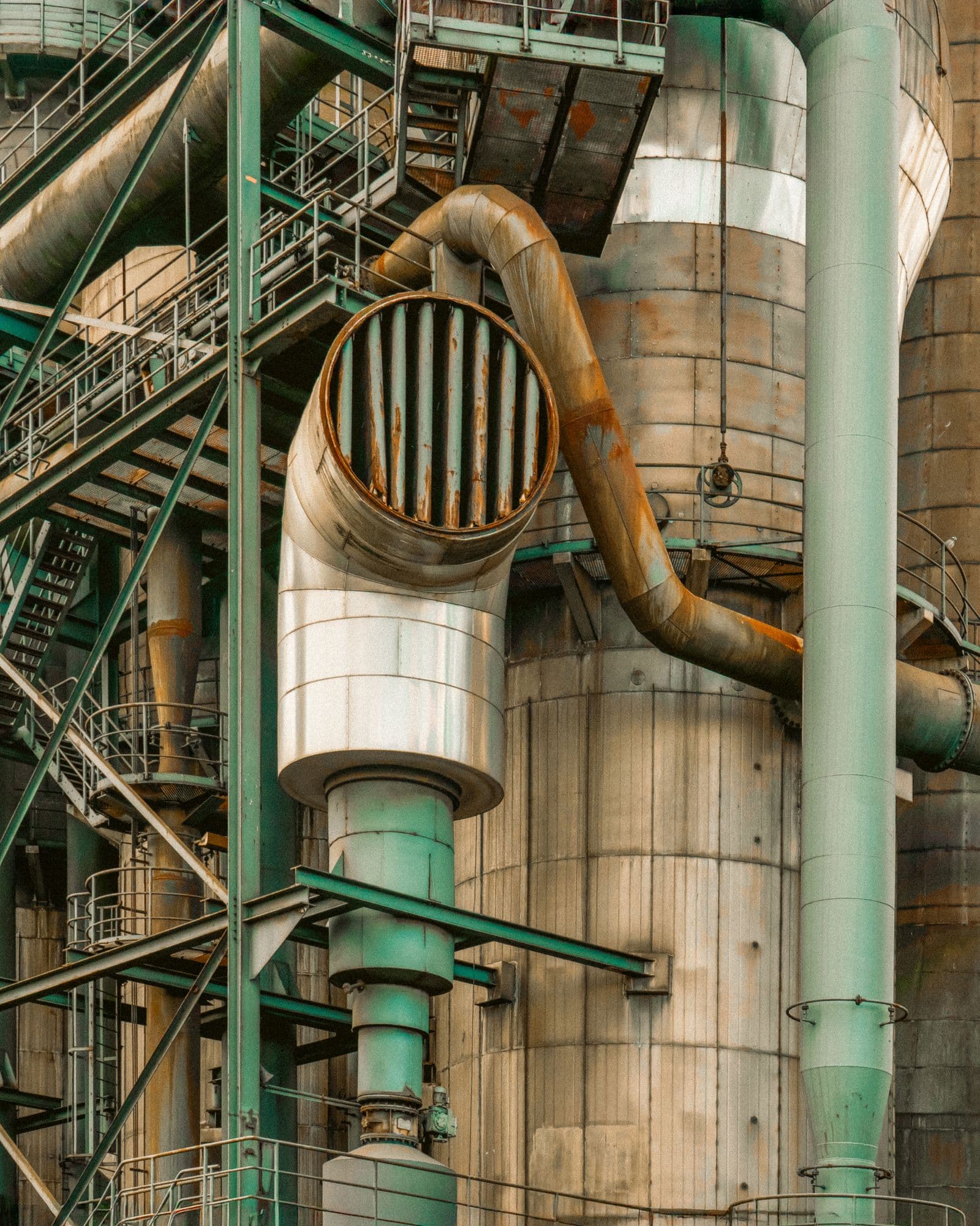 Heavy industrial piping, ducts, and steel infrastructure at a manufacturing plant