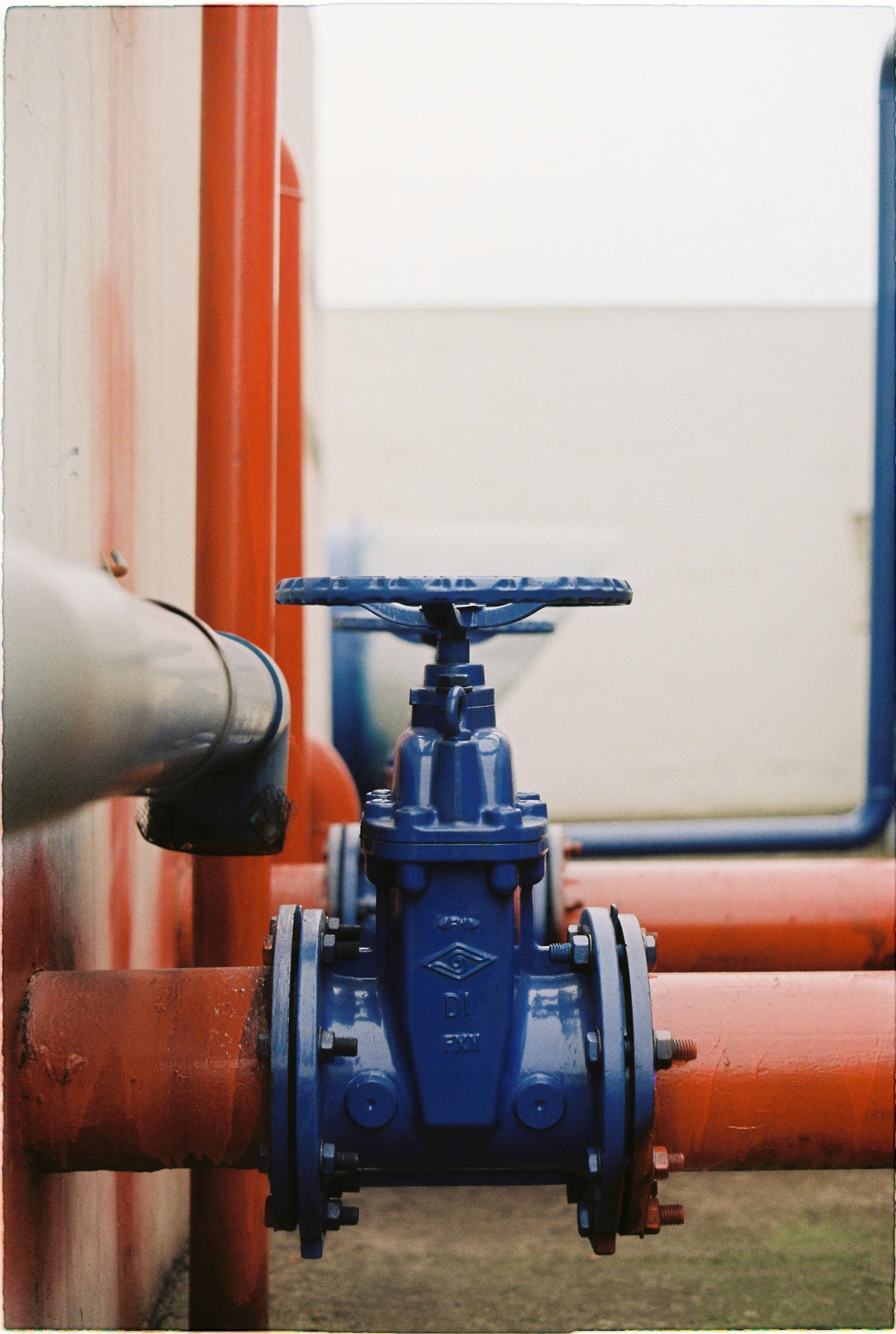 Industrial gate valve on flanged piping system — valves and piping are key components in both gear pump and centrifugal pump installations